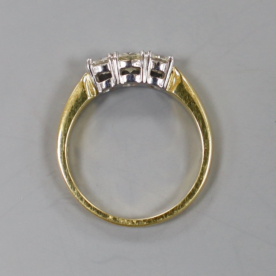 A modern 18ct gold and plat, three stone diamond set ring, size M, gross weight 4.1 grams